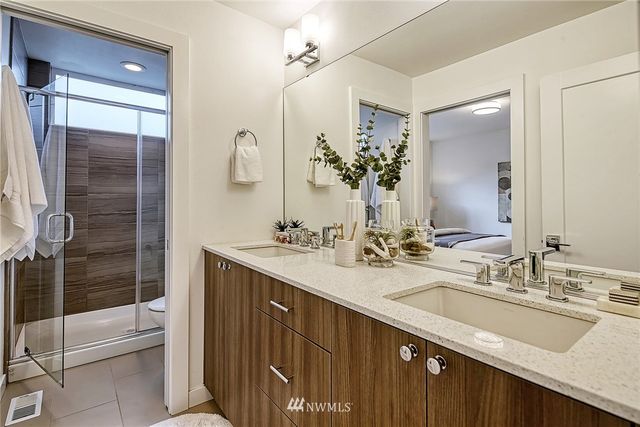 a bathroom with a double vanity sink a and a mirror