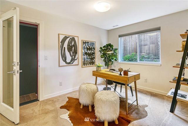 a living room with furniture a window and a potted plant