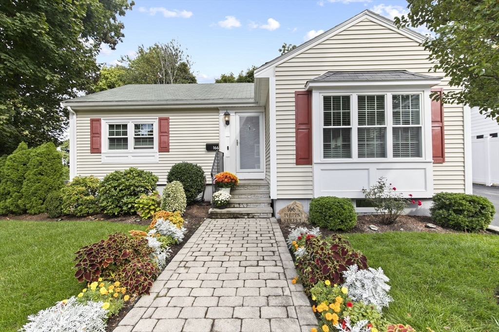 a front view of a house with garden