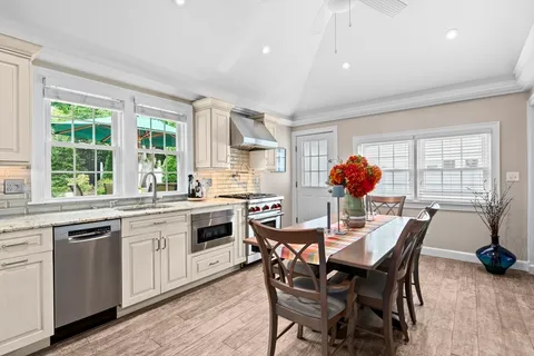a dining room filled counter top space a sink and a window