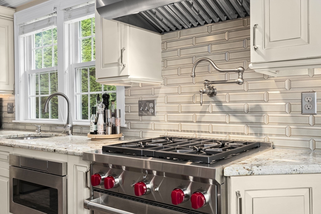 166 Phipps Street Quincy, MA 02169 - Photo 4 of 21 a stove top oven sitting inside of a kitchen
