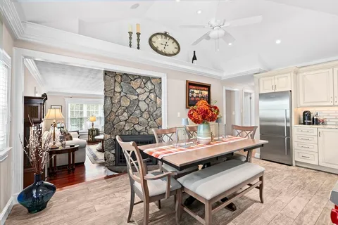 a view of a dining room with furniture a chandelier and wooden floor