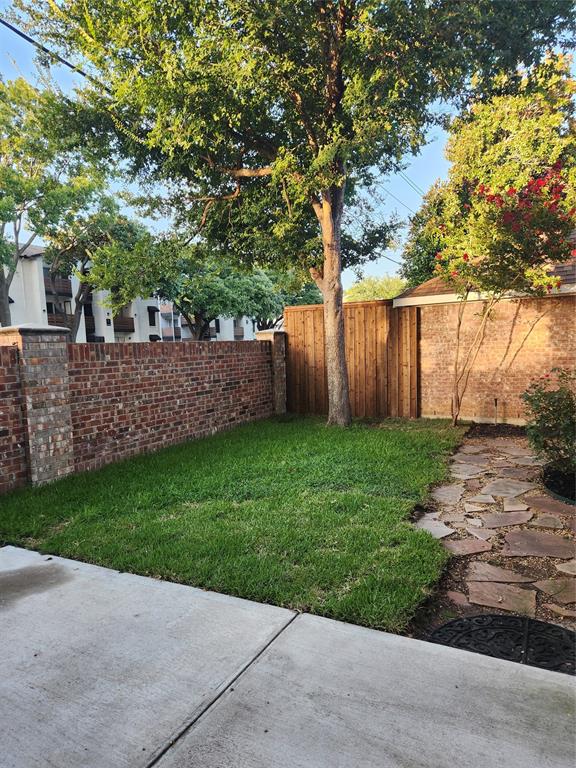 4175 Midrose Trail Dallas, TX 75287 - Photo 13 of 14 Private outdoor space featuring a lush lawn, mature tree, and flagstone pathway