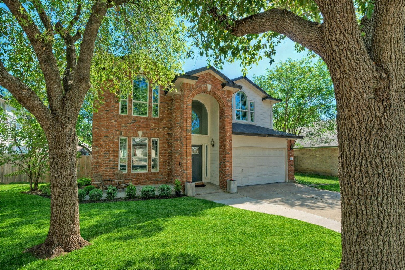 4518 Tello Path Austin, TX 78749 - Photo 1 of 1 Ai - View of front facade featuring brick siding, driveway, and an attached garage