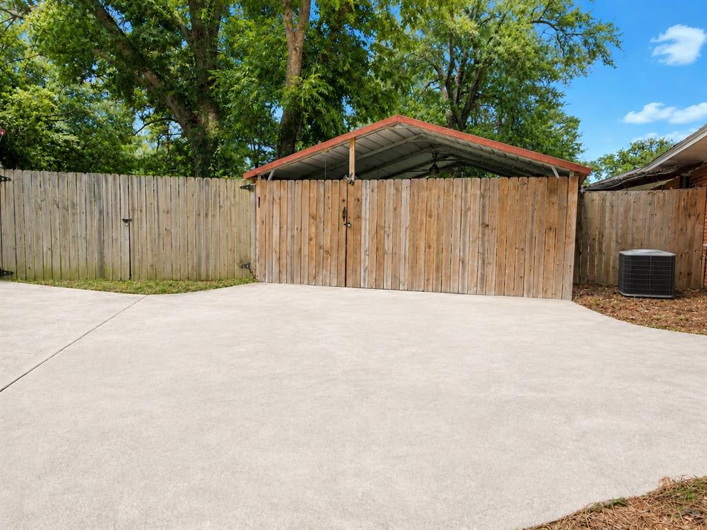 409 Poe Street Quitman, TX 75783 - Photo 16 of 19 Fenced Carport Area