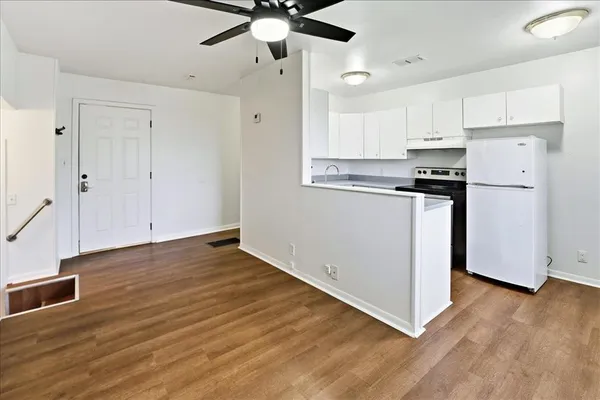a kitchen with a sink stove and refrigerator