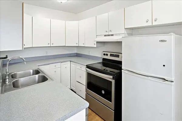 a kitchen with cabinets and appliances