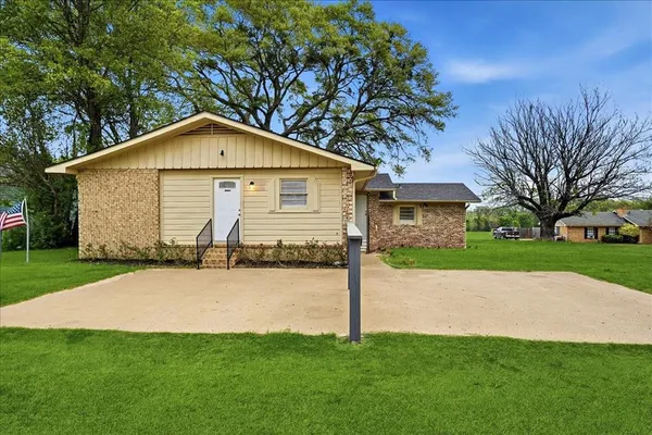 a front view of house with yard and green space
