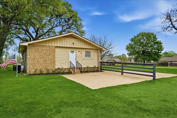 a view of a house with a yard and sitting area