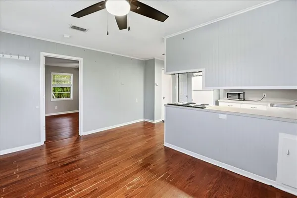 a view of kitchen with granite countertop cabinets and wooden floor