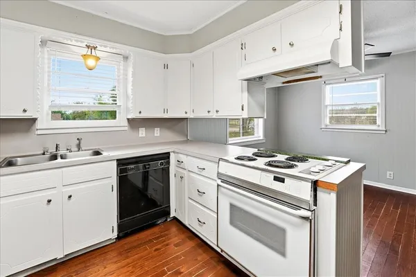 a kitchen with cabinets appliances and a window