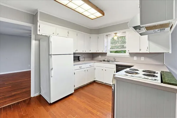 a kitchen with a white cabinets and white appliances
