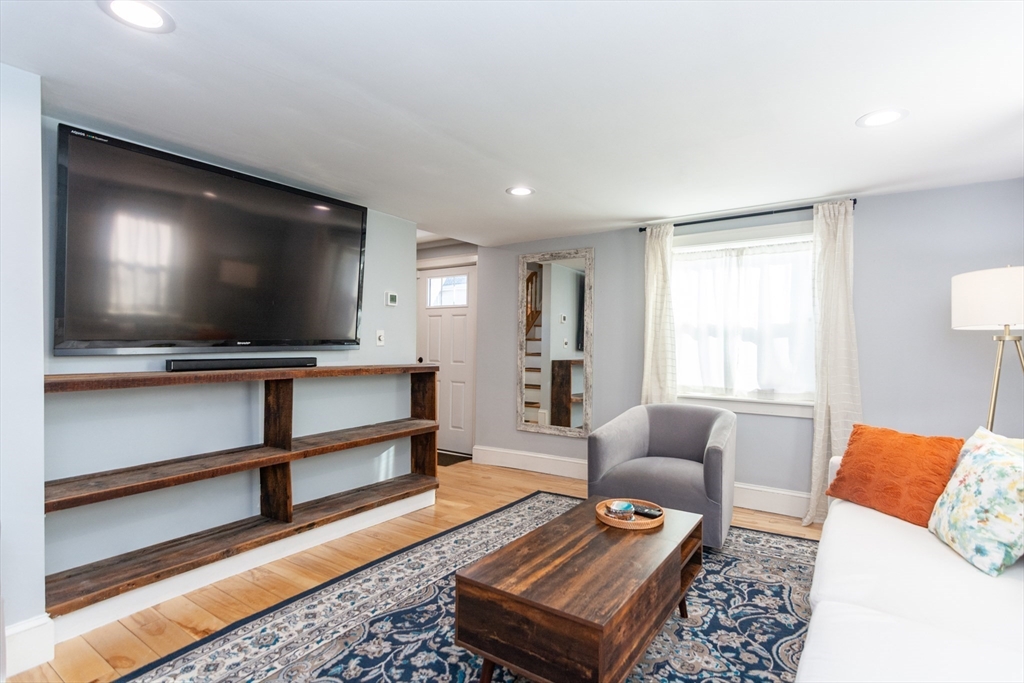 38 Colonial Drive Dedham, MA 02026 - Photo 11 of 28 a living room with furniture and a flat screen tv