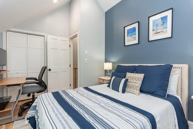 a bedroom with a bed and a desk