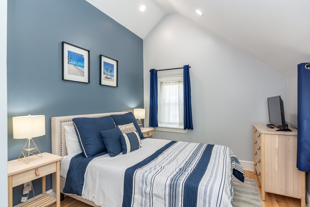 38 Colonial Drive Dedham, MA 02026 - Photo 18 of 28 a bed room with a bed and a flat screen tv