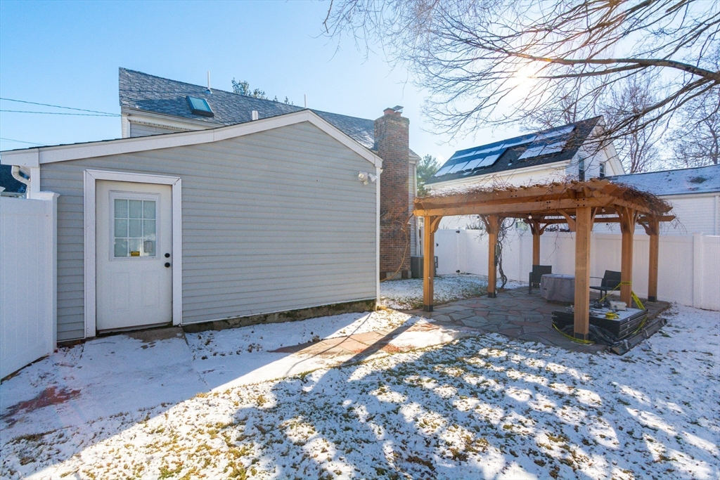 38 Colonial Drive Dedham, MA 02026 - Photo 20 of 28 a view of a patio with a table and chairs under an umbrella