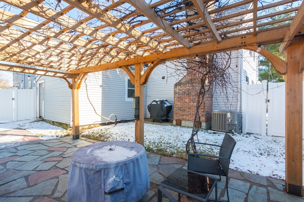 38 Colonial Drive Dedham, MA 02026 - Photo 23 of 28 a backyard of a house with table and chairs