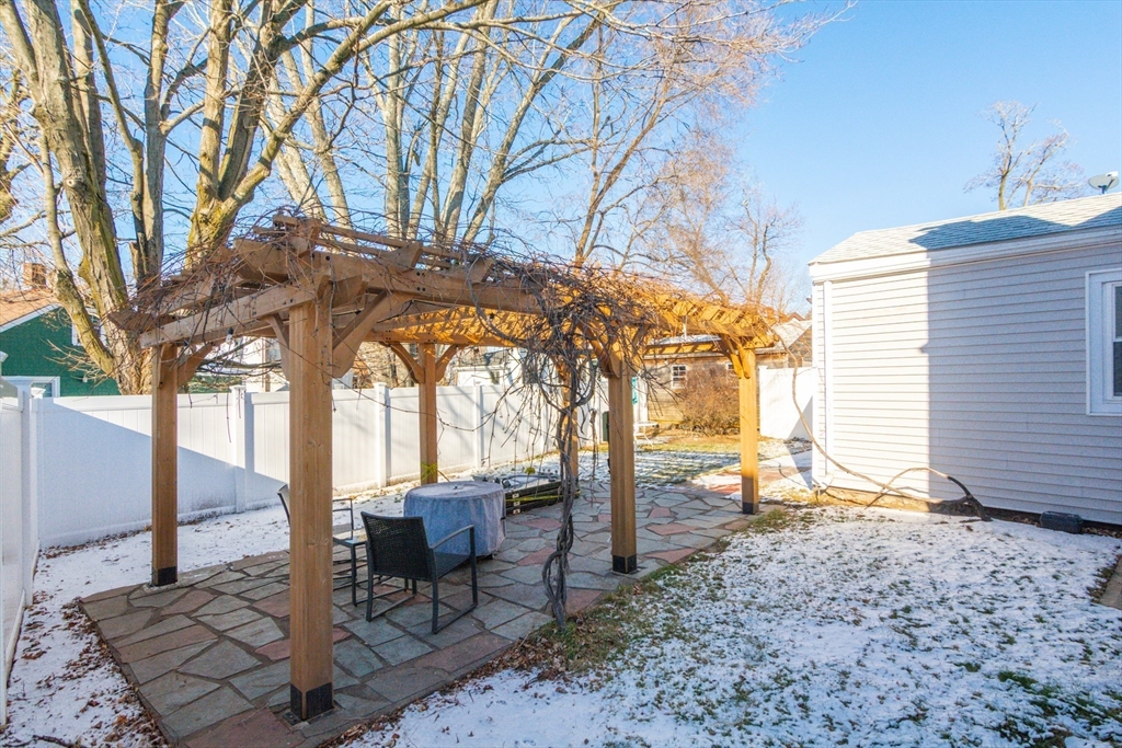 38 Colonial Drive Dedham, MA 02026 - Photo 5 of 28 a view of a chairs and fire pit in the backyard