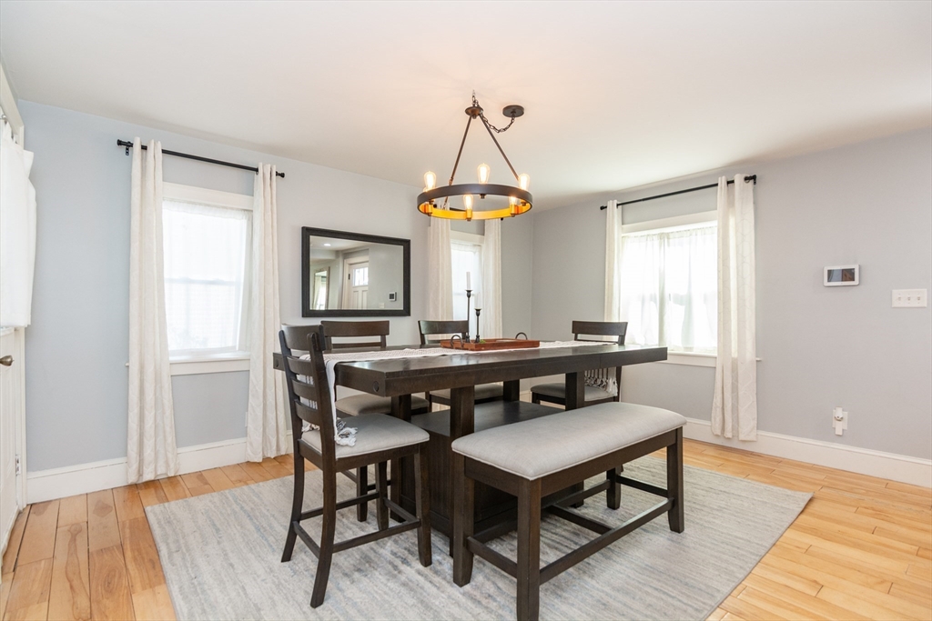 38 Colonial Drive Dedham, MA 02026 - Photo 7 of 28 a living room with a table and a window