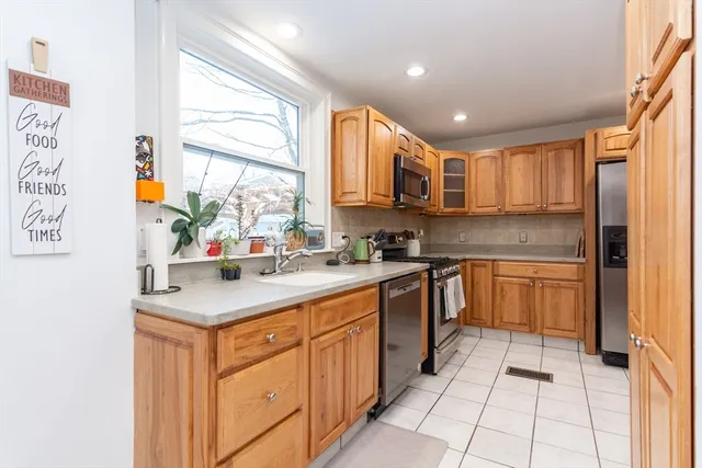 a kitchen with stainless steel appliances granite countertop a sink and cabinets
