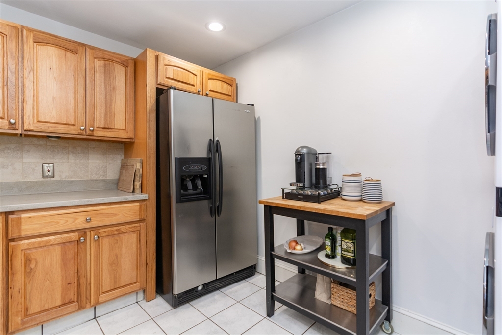 38 Colonial Drive Dedham, MA 02026 - Photo 9 of 28 a kitchen with stainless steel appliances a refrigerator and cabinets