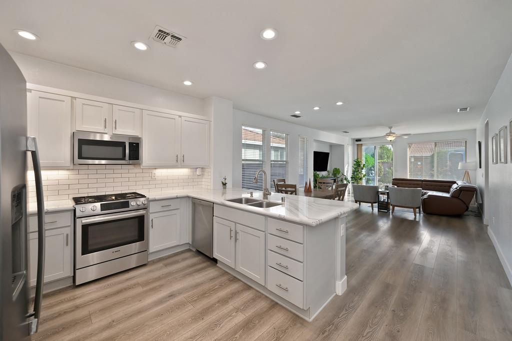 250 Pelican Bay Circle Sacramento, CA 95835 - Photo 23 of 71 a kitchen with a sink stainless steel appliances and cabinets