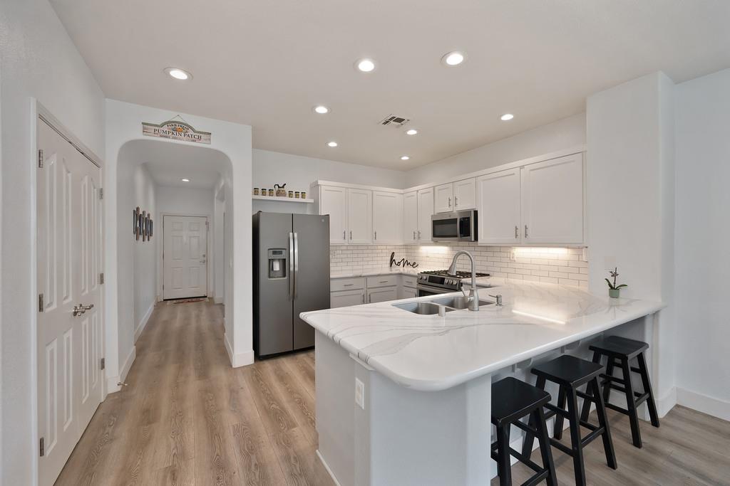 250 Pelican Bay Circle Sacramento, CA 95835 - Photo 24 of 71 a kitchen with a sink a refrigerator and chairs