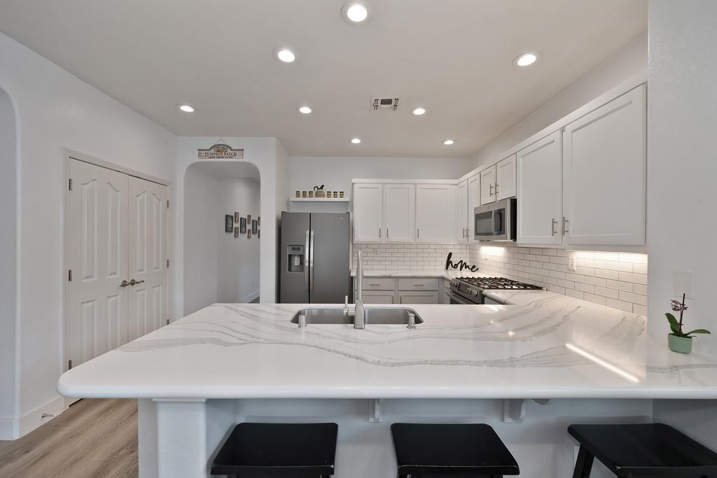 250 Pelican Bay Circle Sacramento, CA 95835 - Photo 3 of 71 a large kitchen with kitchen island a sink stainless steel appliances and cabinets
