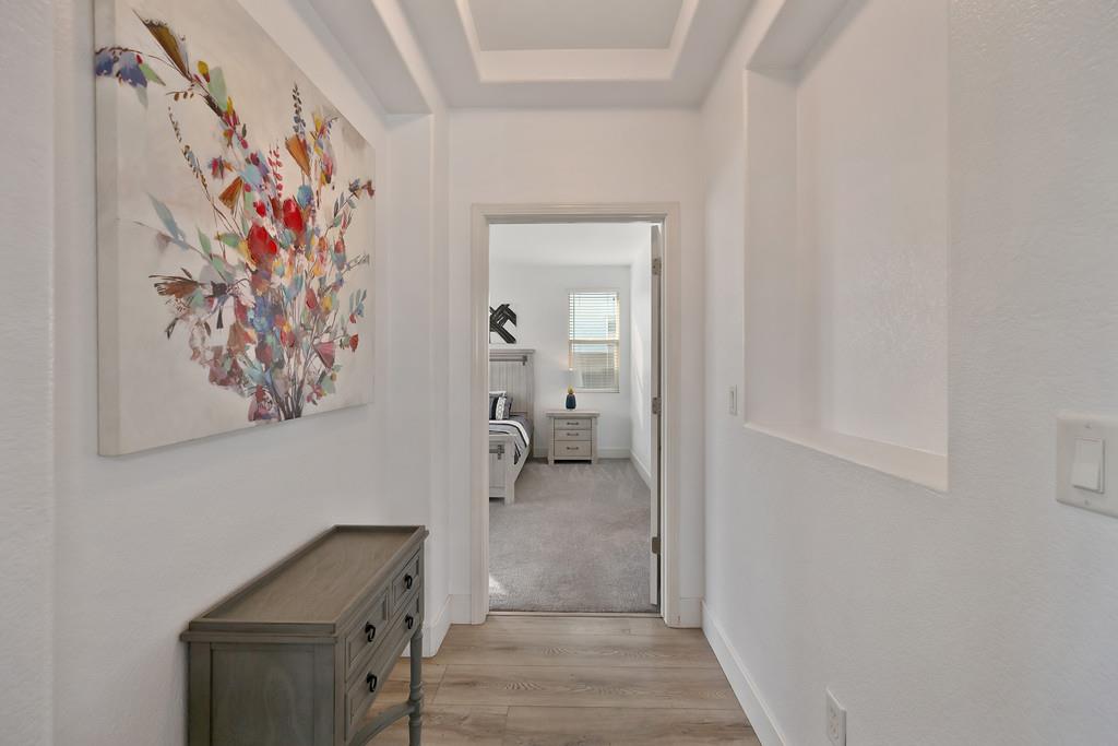 250 Pelican Bay Circle Sacramento, CA 95835 - Photo 35 of 71 a hallway with painting on the wall and a mirror