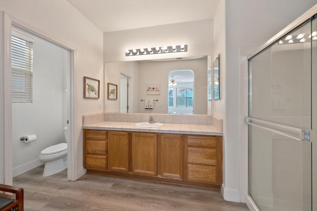 250 Pelican Bay Circle Sacramento, CA 95835 - Photo 41 of 71 a spacious bathroom with a granite countertop sink a toilet and a mirror