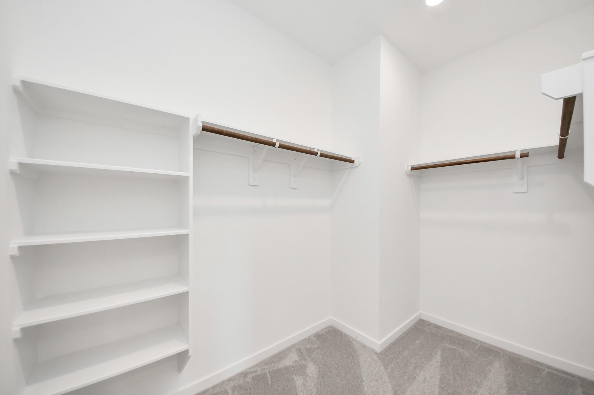 10650 Ellerston Road Cleveland, TX 77327 - Photo 16 of 25 The walk-in closet features built-in shelving, offering both space and functionality