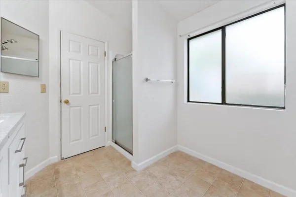an empty room with windows and closet