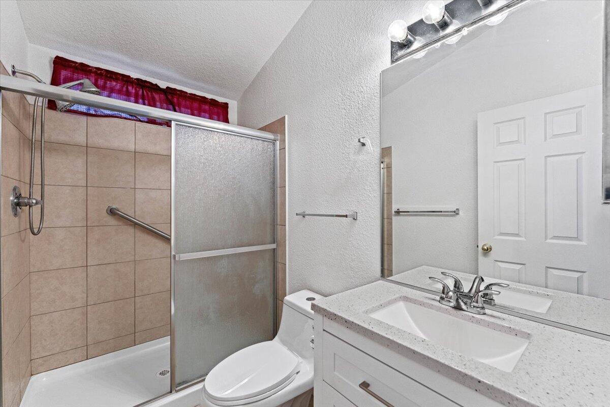 977 Tuberose Trail Redding, CA 96003 - Photo 16 of 31 a bathroom with a sink toilet and shower