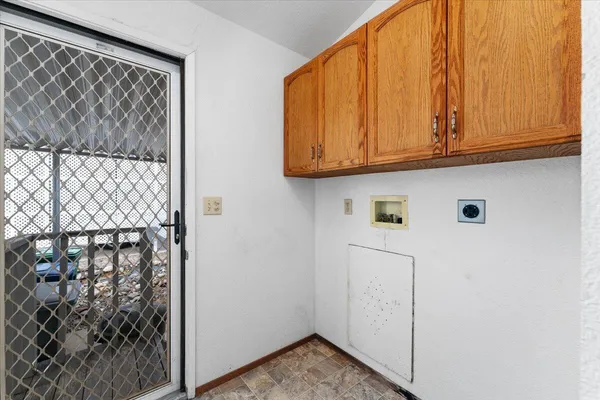 a view of a patio with table and chairs
