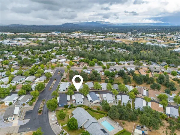 an aerial view of a house with a yard