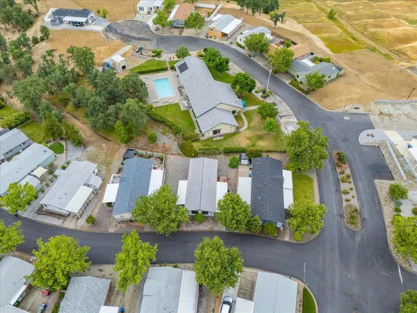 an aerial view of residential houses with city view