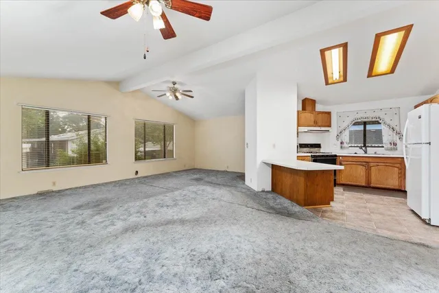 a living room with stainless steel appliances kitchen island furniture and a kitchen view