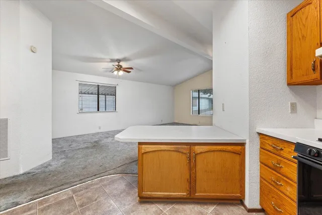 a kitchen with a stove a sink and a window