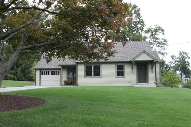 15 Griffith Lane Ridgefield, CT 06877 - Photo 1 of 1 a front view of a house with a yard and trees