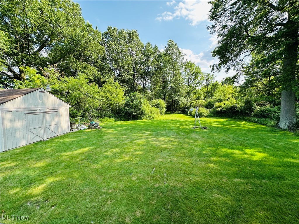 1684 Morris Street Mineral Ridge, OH 44440 - Photo 21 of 50 View of green lawn with an outbuilding and a garage