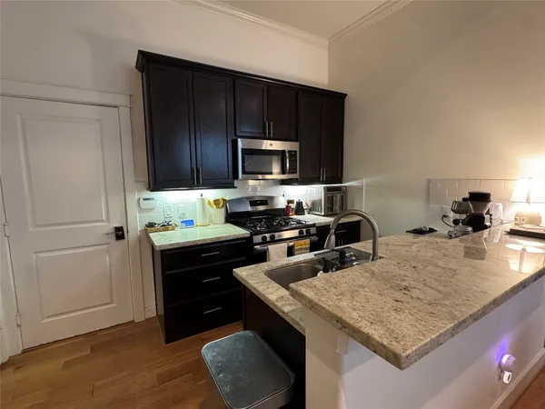 a kitchen with a refrigerator a stove a sink and a oven