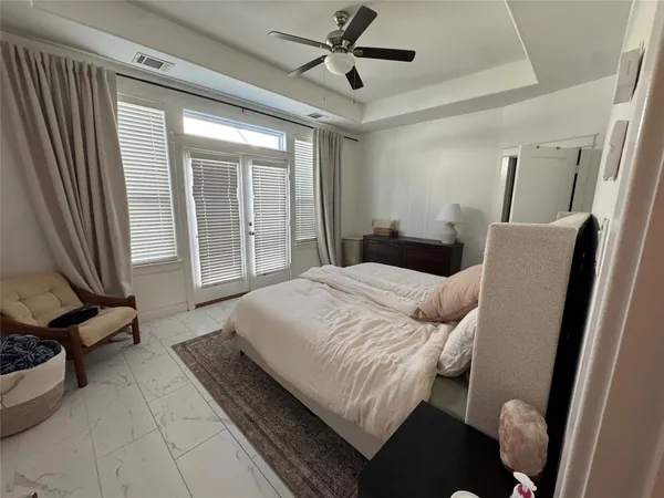 a bedroom with a bed couch and a window