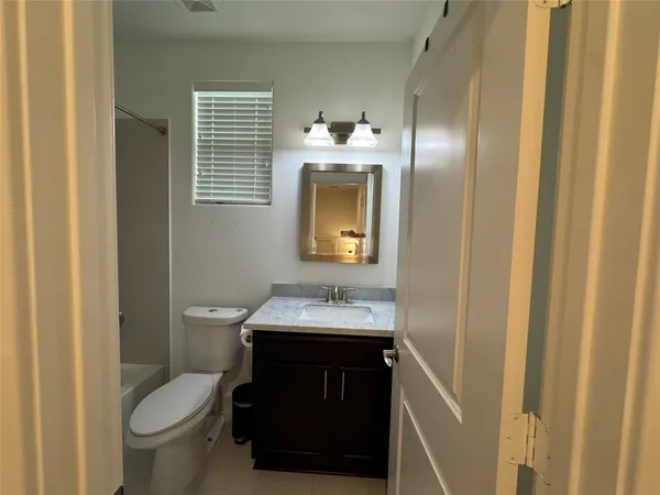 a bathroom with a sink toilet and mirror