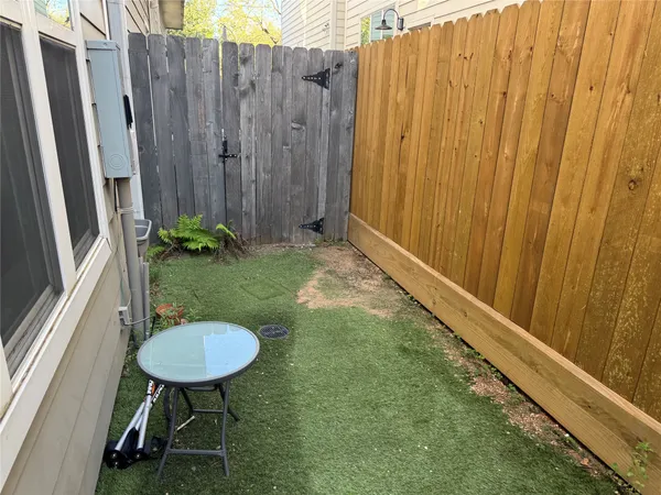 a backyard of a house with table and chairs
