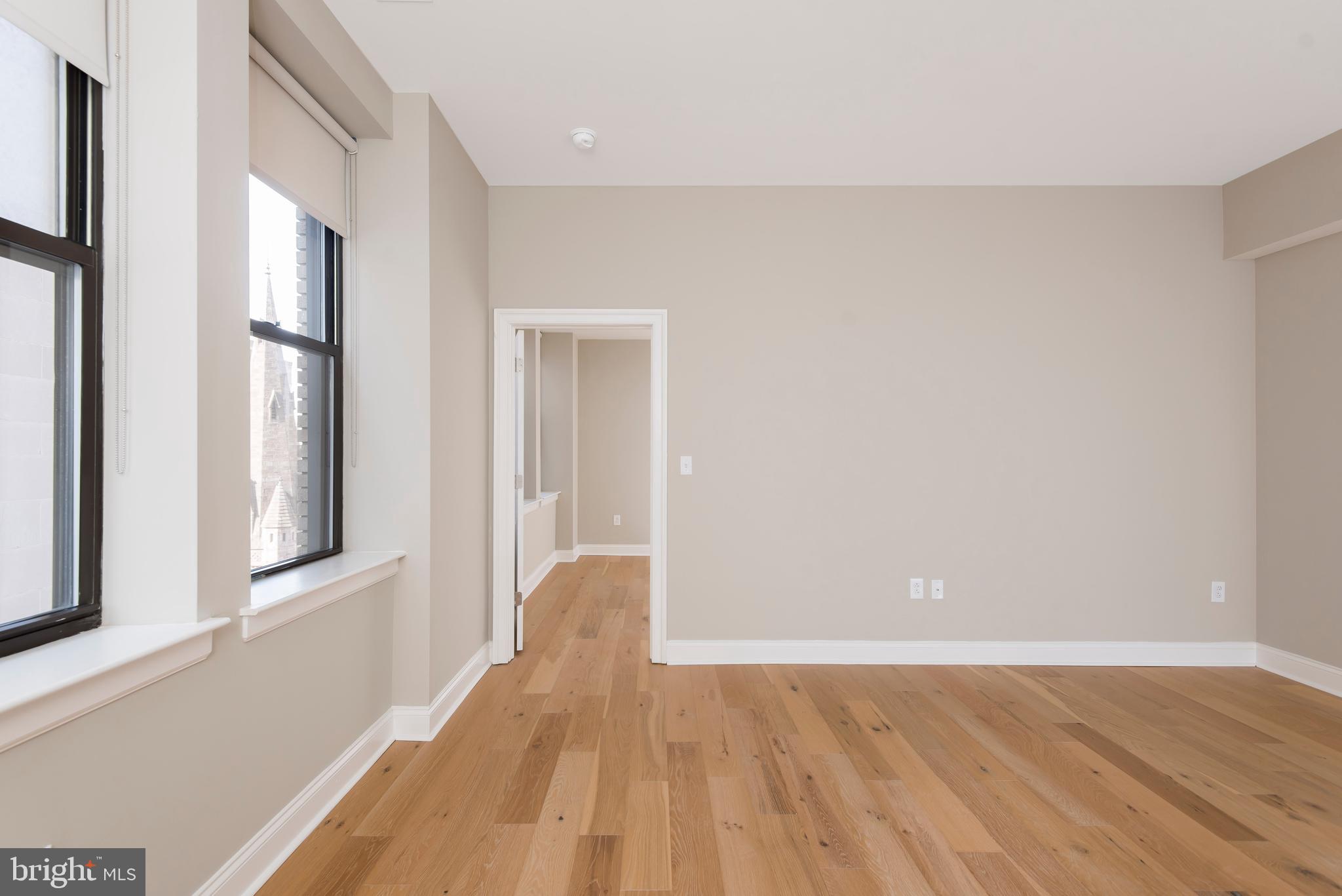 220 South 16th Street, Unit 902 Philadelphia, PA 19102 - Photo 11 of 16 a view of a room with wooden floor and a window