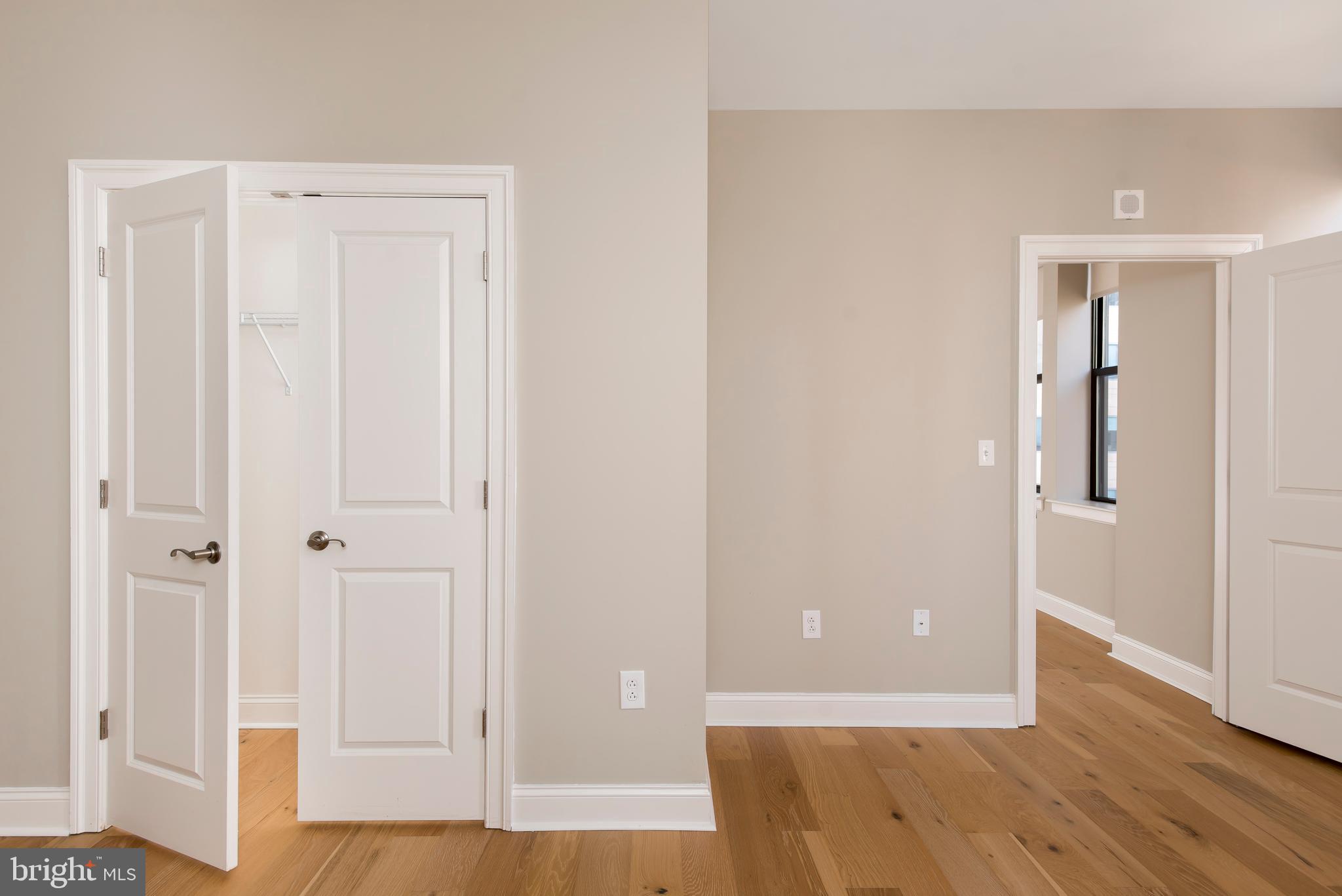 220 South 16th Street, Unit 902 Philadelphia, PA 19102 - Photo 13 of 16 an empty room with wooden floor and closet