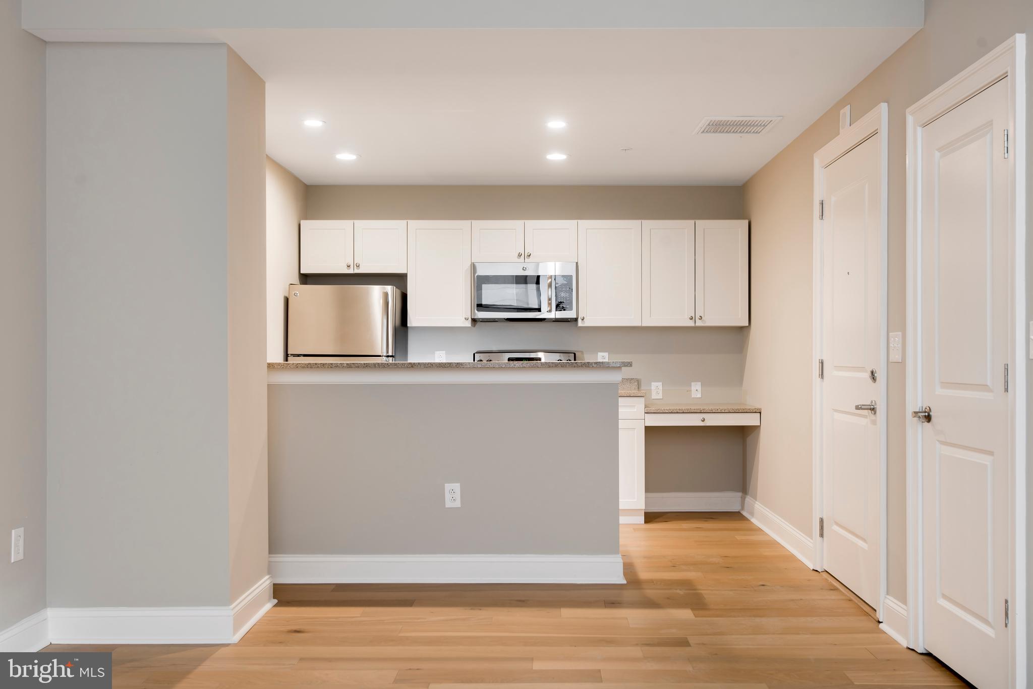 220 South 16th Street, Unit 902 Philadelphia, PA 19102 - Photo 6 of 16 a kitchen with stainless steel appliances granite countertop a stove a sink and a refrigerator