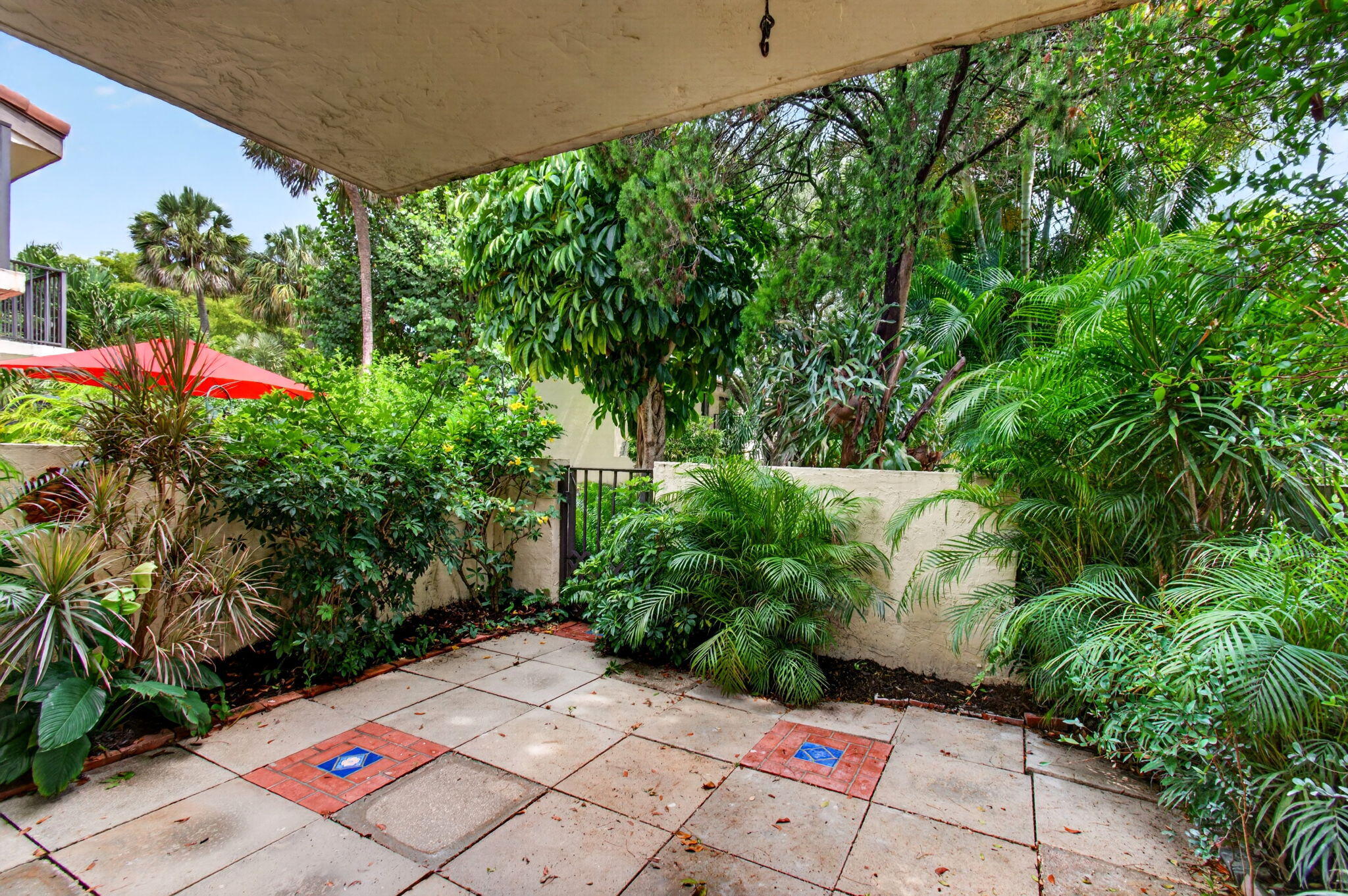 1330 Northwest 13th Street, Unit 12 Boca Raton, FL 33486 - Photo 43 of 52 a small garden covered with tall trees