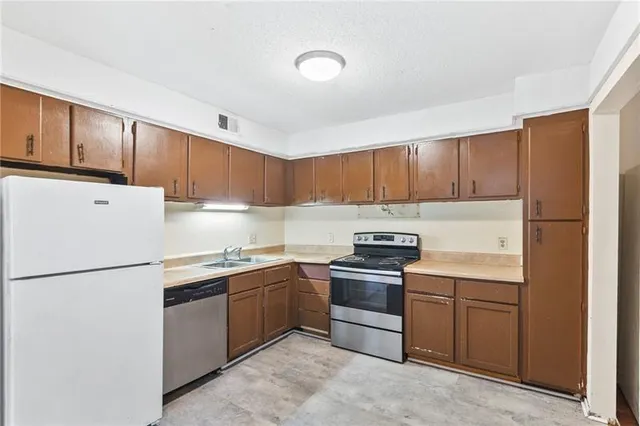 a kitchen with a sink a stove and refrigerator