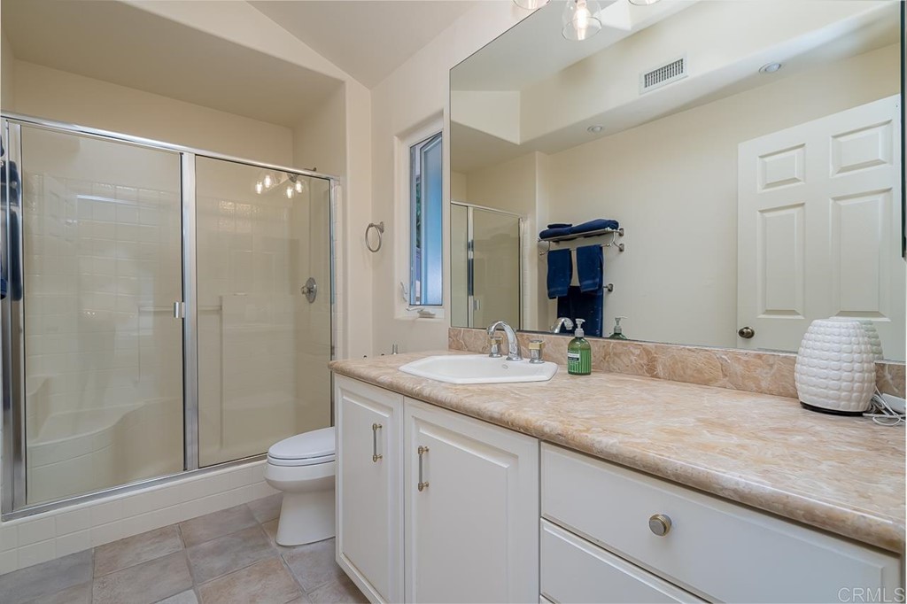 1239 Jamacha Road El Cajon, CA 92019 - Photo 13 of 24 a bathroom with a granite countertop sink a toilet and shower